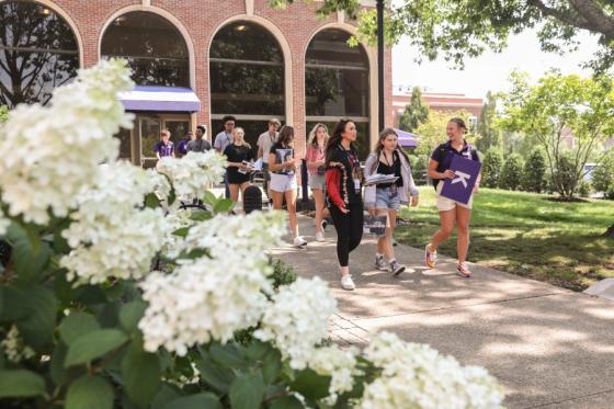 Student orientation staff leading students across campus