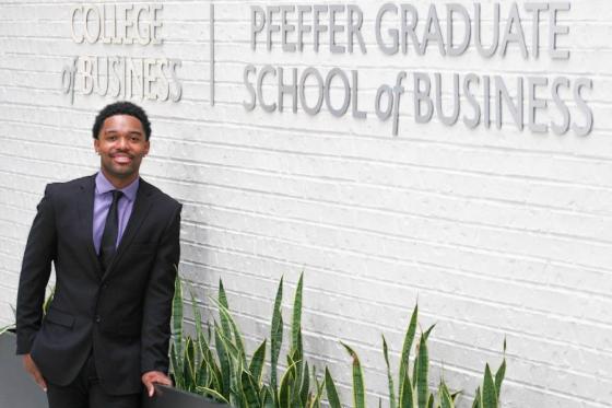 Nate Wallace standing inside the College of Business in the Swang Center. 