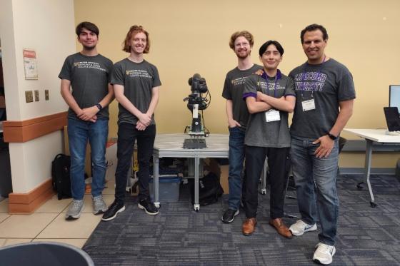 Students and Juan Rojas with the lab's robotic arm