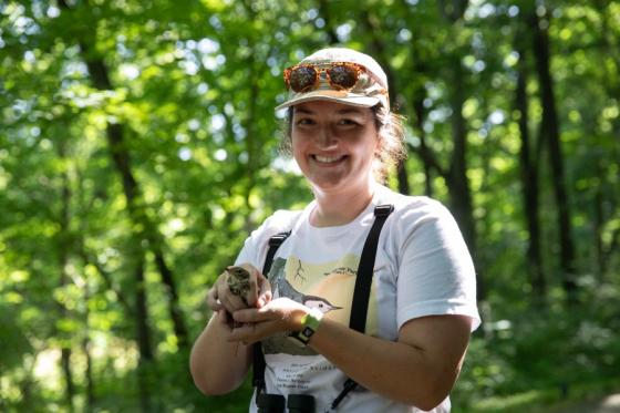 Lexi Price holding a wood thrush bird in Warner Parks