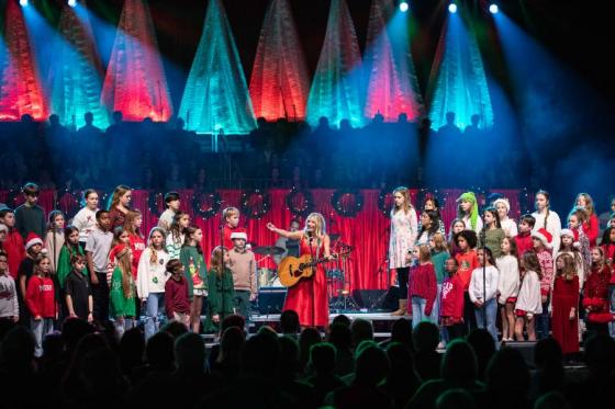 Ellie Holcomb on stage at Lighting of the Green with Lipscomb Academy students