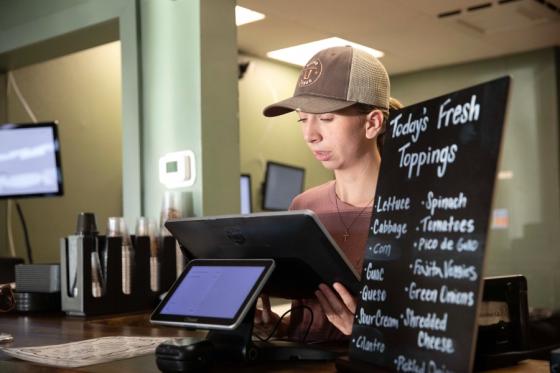 IDEAL student London Latham taking orders at Victor Tango