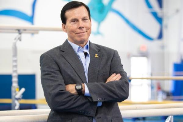portrait of Drew Davis in a gymnastics gym 