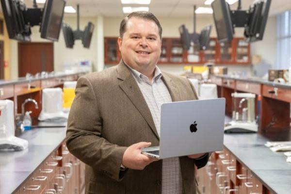 Jay Dorris with his computer in a pharmacy lab